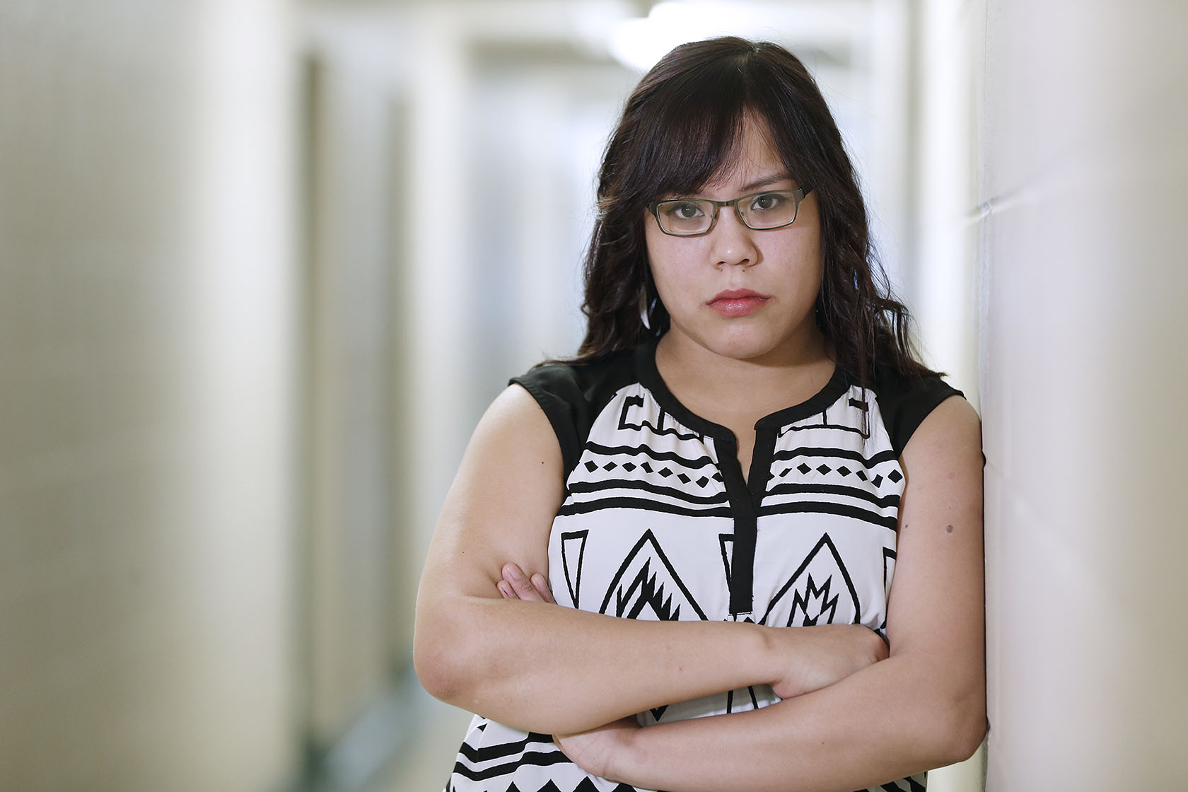Photo of Cheryl Bruce, arms crossed, serious expression.